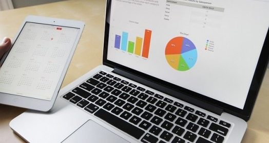 working on a laptop and a tablet